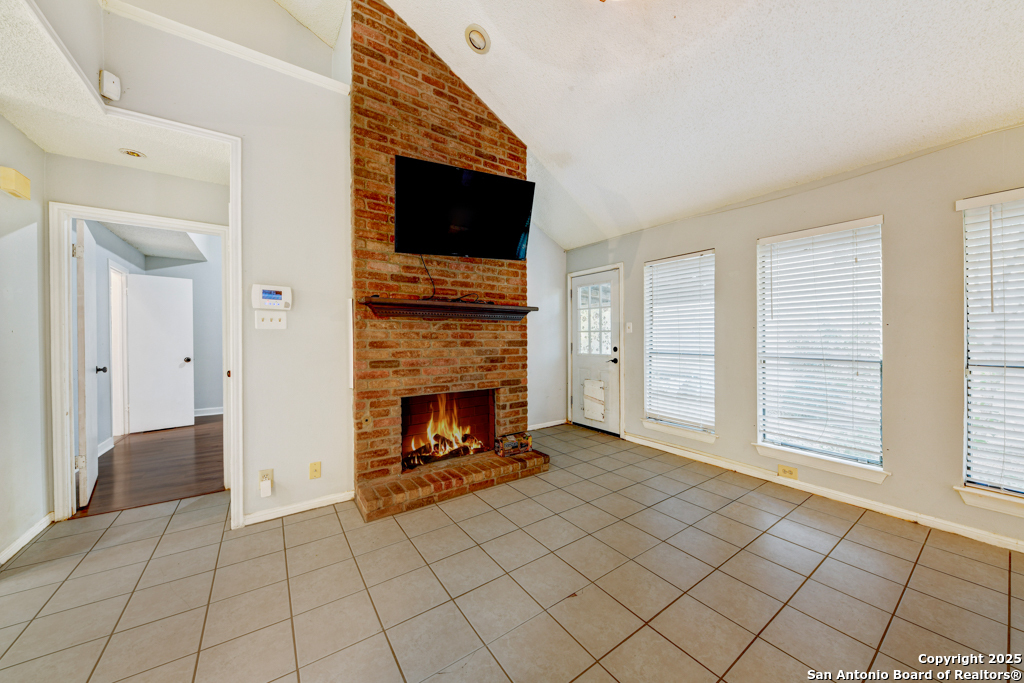 15010 Spring Shower San Antonio, TX 78247 - Photo 7 of 27 a view of an empty room with window and fire place