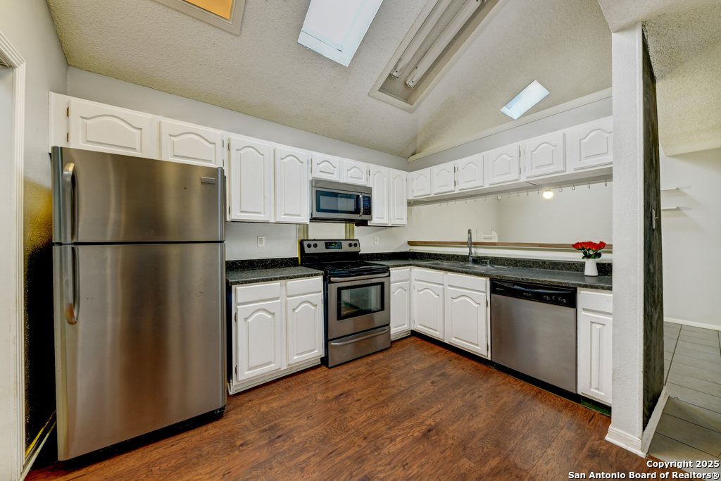 15010 Spring Shower San Antonio, TX 78247 - Photo 9 of 27 a kitchen with a refrigerator stove and microwave