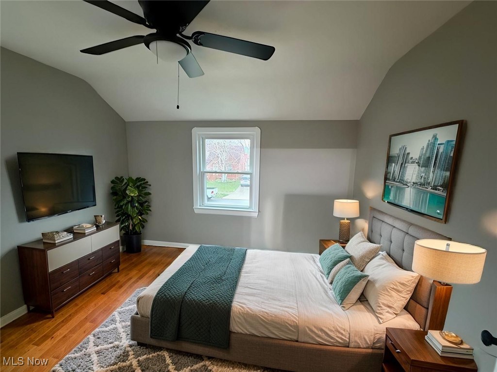 6807 Gerald Avenue Parma, OH 44129 - Photo 15 of 25 Bedroom featuring baseboards, a ceiling fan, light wood-style floors, and vaulted ceiling virtually staged