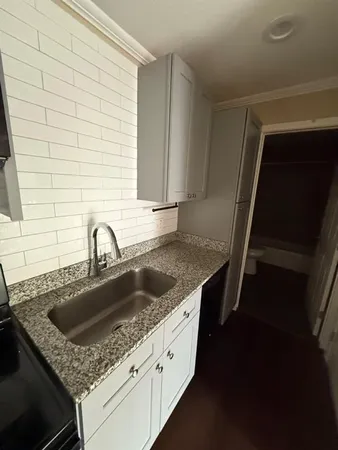 a kitchen with a sink and cabinets