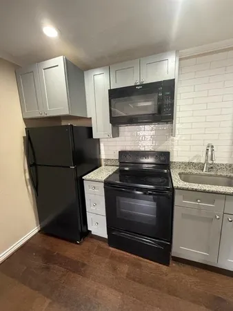 a kitchen with a stove microwave and refrigerator