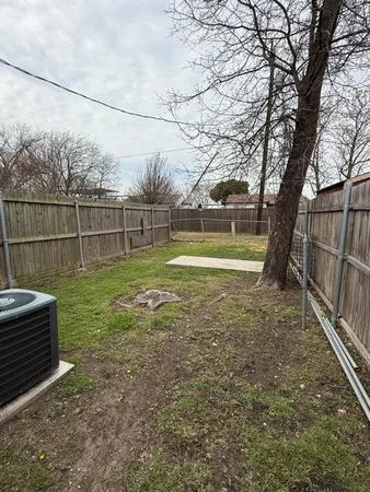 a view of a backyard with wooden fence