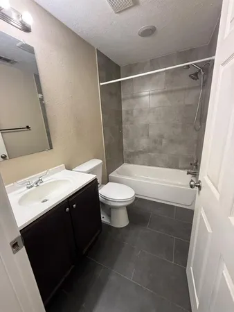 a bathroom with a sink mirror toilet and shower