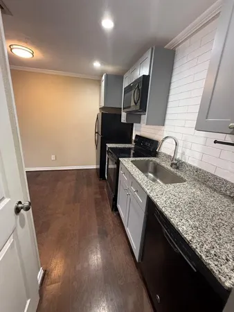 a kitchen with sink and refrigerator