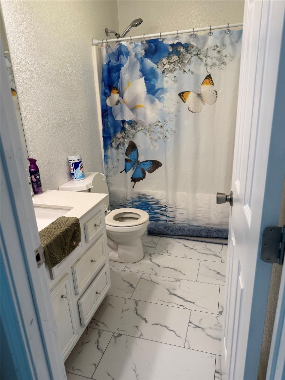 968 Red Town Road Elgin, TX 78621 - Photo 11 of 36 Bathroom featuring marble look tiles, vanity, and a textured wall