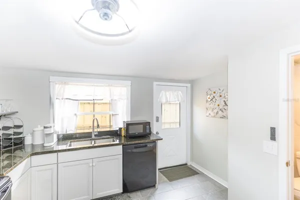 a kitchen with a sink and cabinets