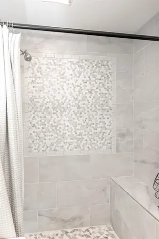 a bathroom with a shower curtain and a shower curtain