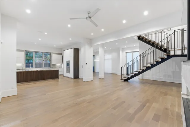 a view of a hall with stairs and a living room