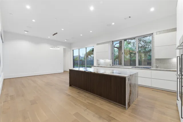a view of kitchen with stainless steel appliances granite countertop cabinets and window