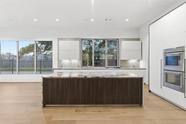 a kitchen with granite countertop a sink and a wooden cabinets