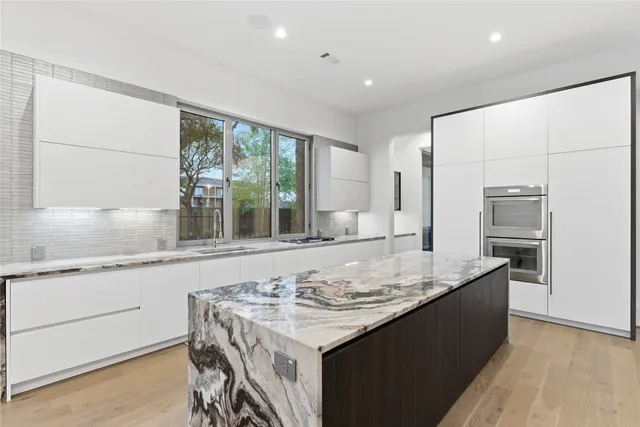 a kitchen with granite countertop a sink and a stove