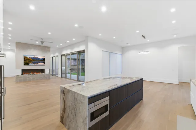 a kitchen with stainless steel appliances granite countertop a sink and a stove top oven