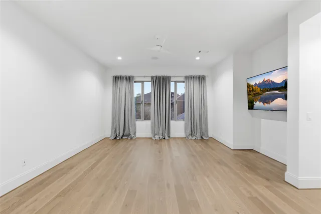 a view of a livingroom with wooden floor and closet