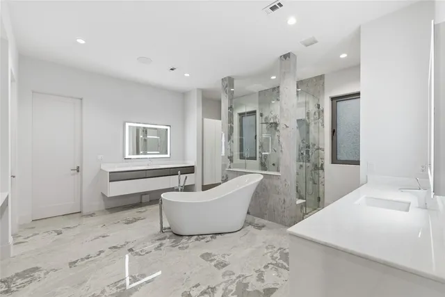 a spacious bathroom with a bathtub and shower