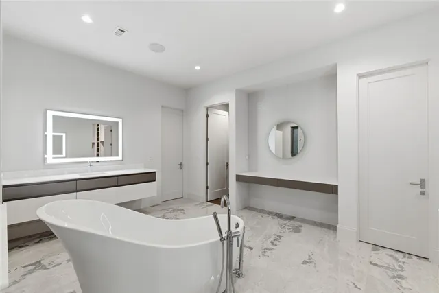 a bathroom with a bathtub and shower