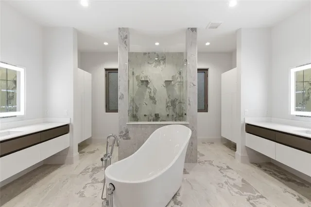 a bathroom with a granite countertop sink a toilet a mirror and shower