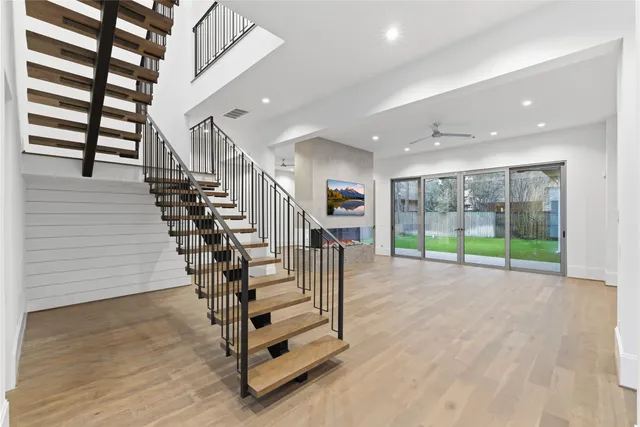 a view of entryway and hall with wooden floor