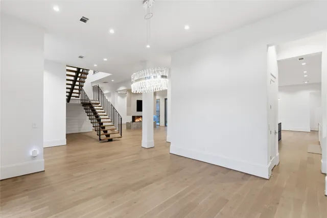 an entryway in a room with wooden floor