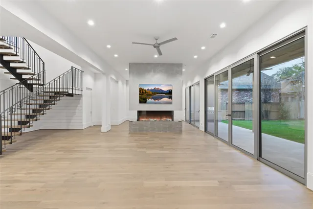 a view of empty room with wooden floor and fireplace