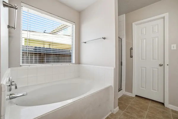 a white bath tub sitting next to a window