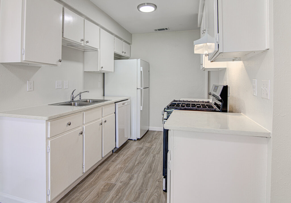 5301 Indio Circle, Unit A Austin, TX 78745 - Photo 9 of 25 A well-lit kitchen with sleek white cabinetry, pristine countertops, and durable flooring.