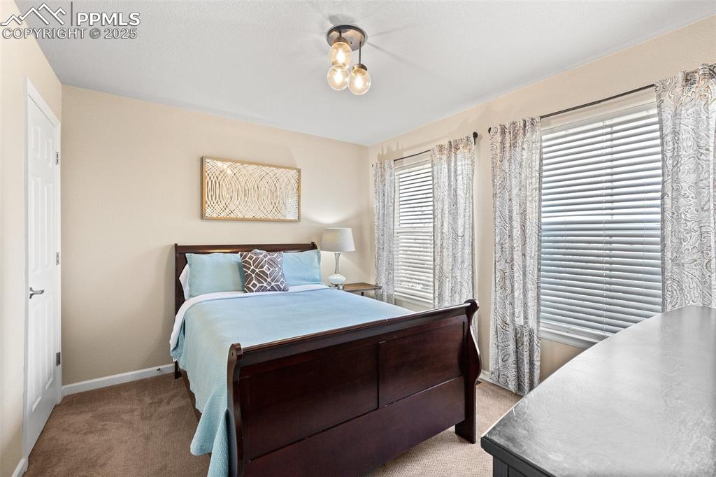 4073 Flash Point Colorado Springs, CO 80907 - Photo 14 of 20 a bedroom with a bed lamp and a window