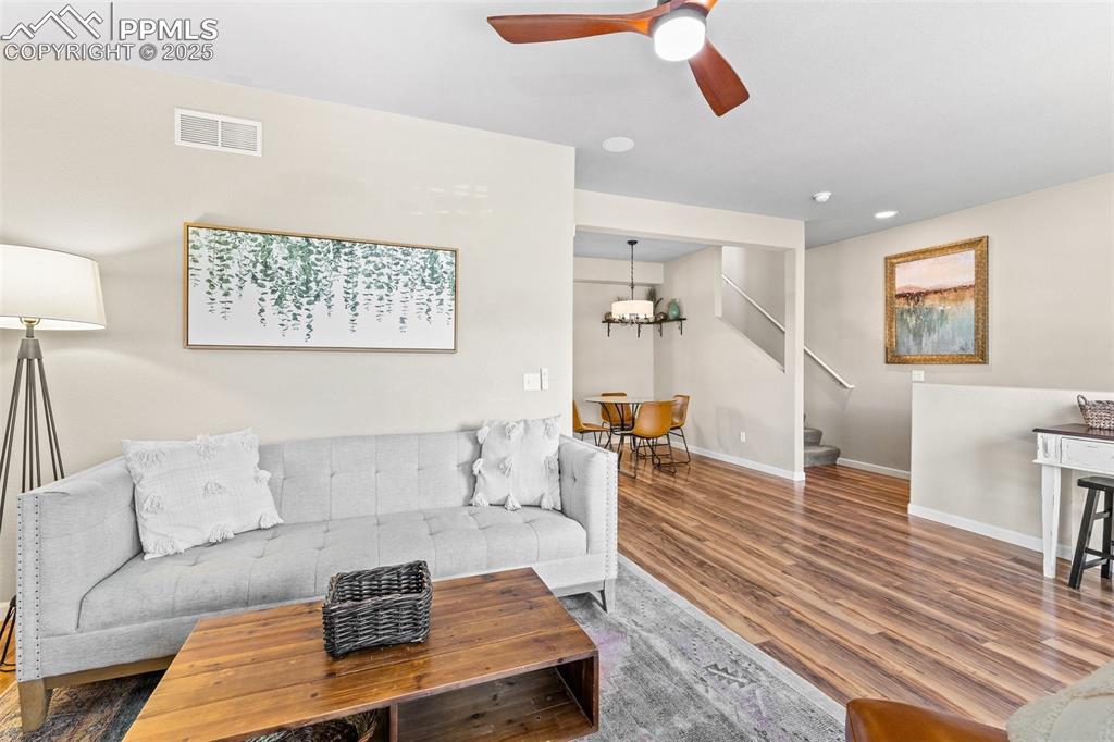 4073 Flash Point Colorado Springs, CO 80907 - Photo 3 of 20 a living room with furniture and a wooden floor