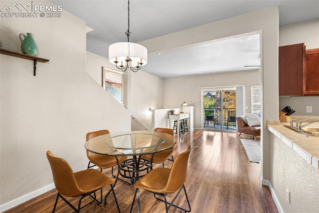 4073 Flash Point Colorado Springs, CO 80907 - Photo 5 of 20 a view of a dining room with furniture window and wooden floor