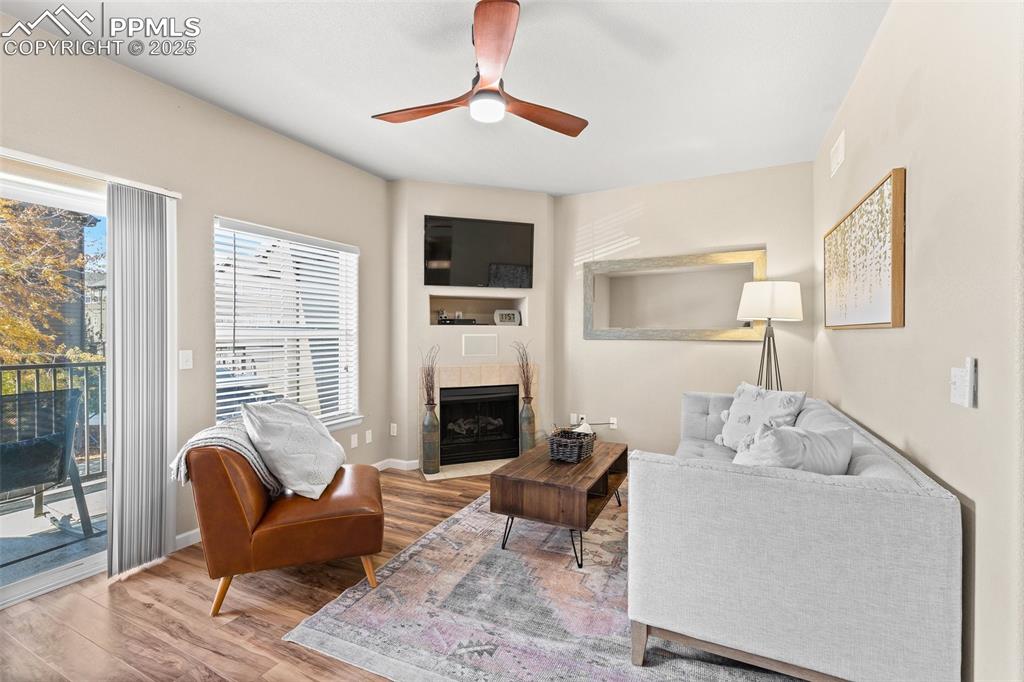 4073 Flash Point Colorado Springs, CO 80907 - Photo 6 of 20 a living room with furniture a fireplace and a flat screen tv