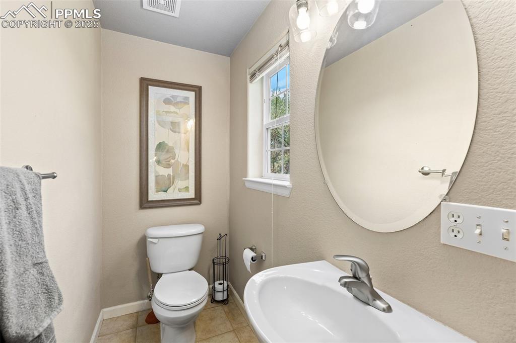 4073 Flash Point Colorado Springs, CO 80907 - Photo 10 of 20 a bathroom with a toilet sink and mirror