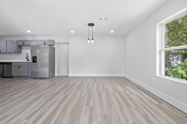 a view of a kitchen with a sink and wooden floor
