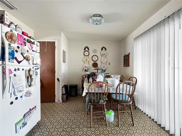 a dining room with furniture and a window