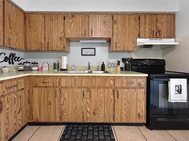 a kitchen with a sink and cabinets