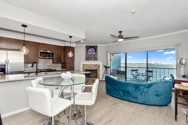 a living room with furniture a chandelier fan and a rug