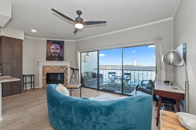 a large kitchen with stainless steel appliances kitchen island a table chairs in it and a wooden floors