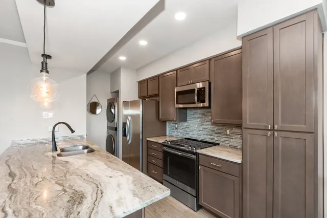 a kitchen with a sink cabinets and wooden floor