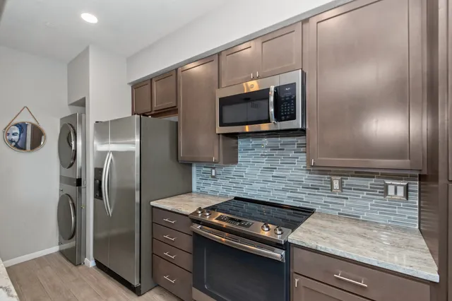 a bathroom with a granite countertop double vanity sink and a mirror