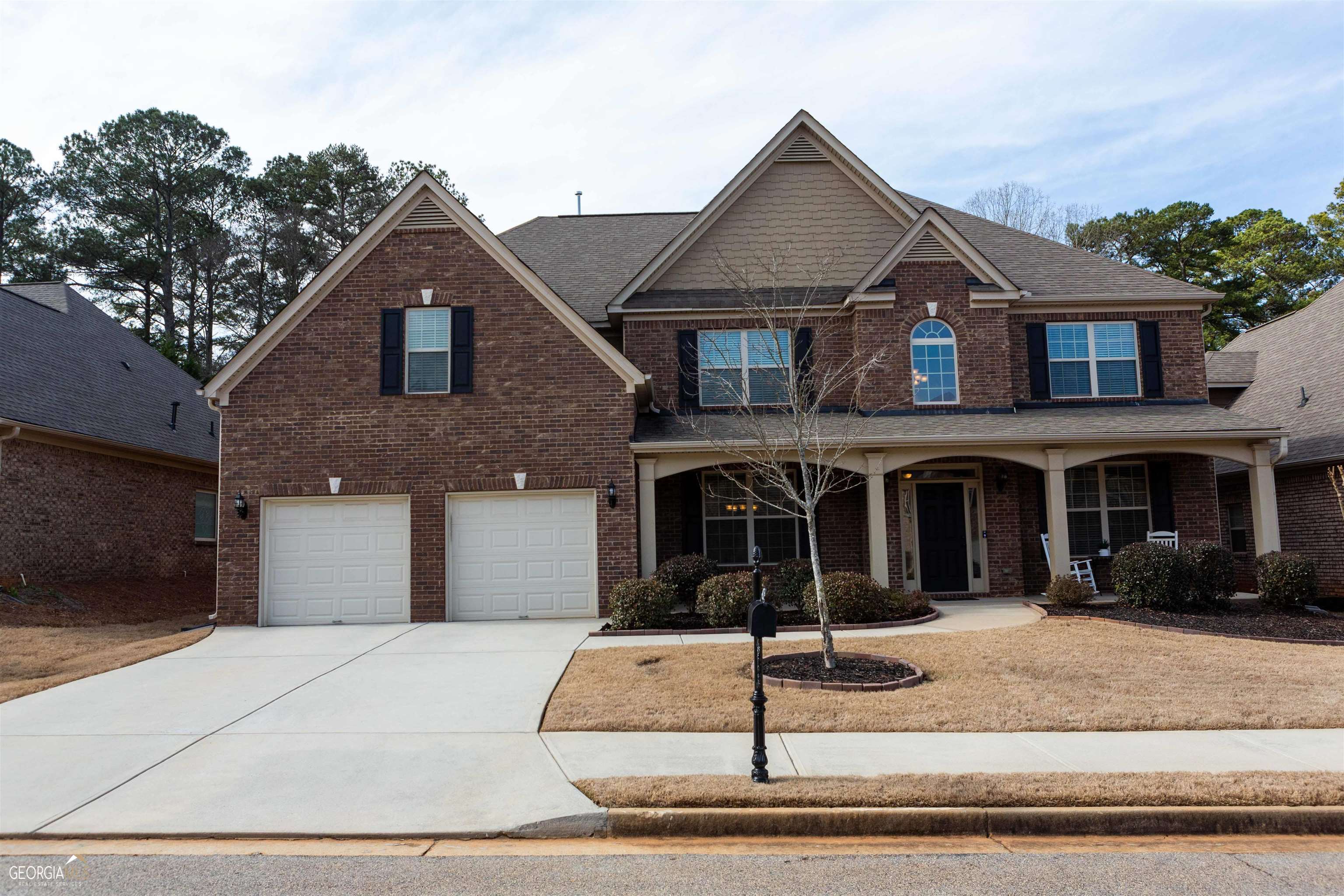 a front view of a house with that has a tree