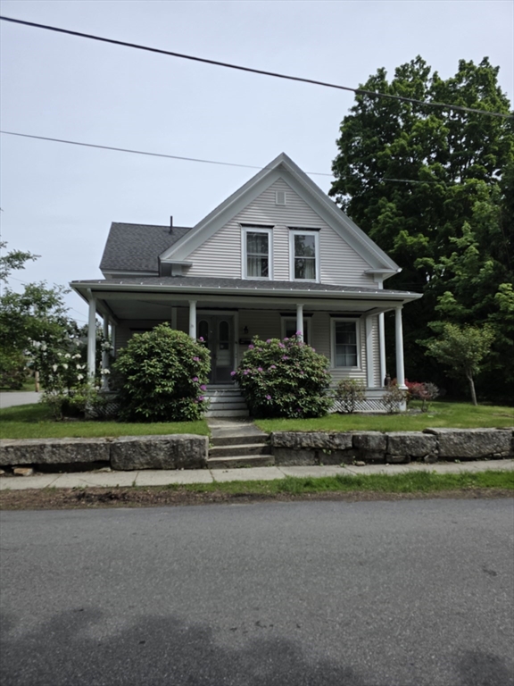 48 Maple Street, Unit 2 Holden, MA 01520 - Photo 1 of 11 a front view of a house with a garden