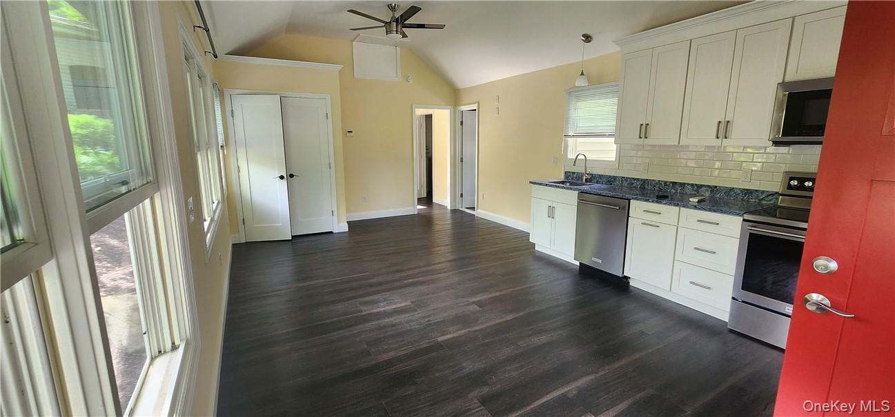 11 Curry Road Mahopac, NY 10541 - Photo 9 of 25 Kitchen featuring stainless steel appliances, Quartz countertop tasteful engineered flooring, white cabinets, and sink