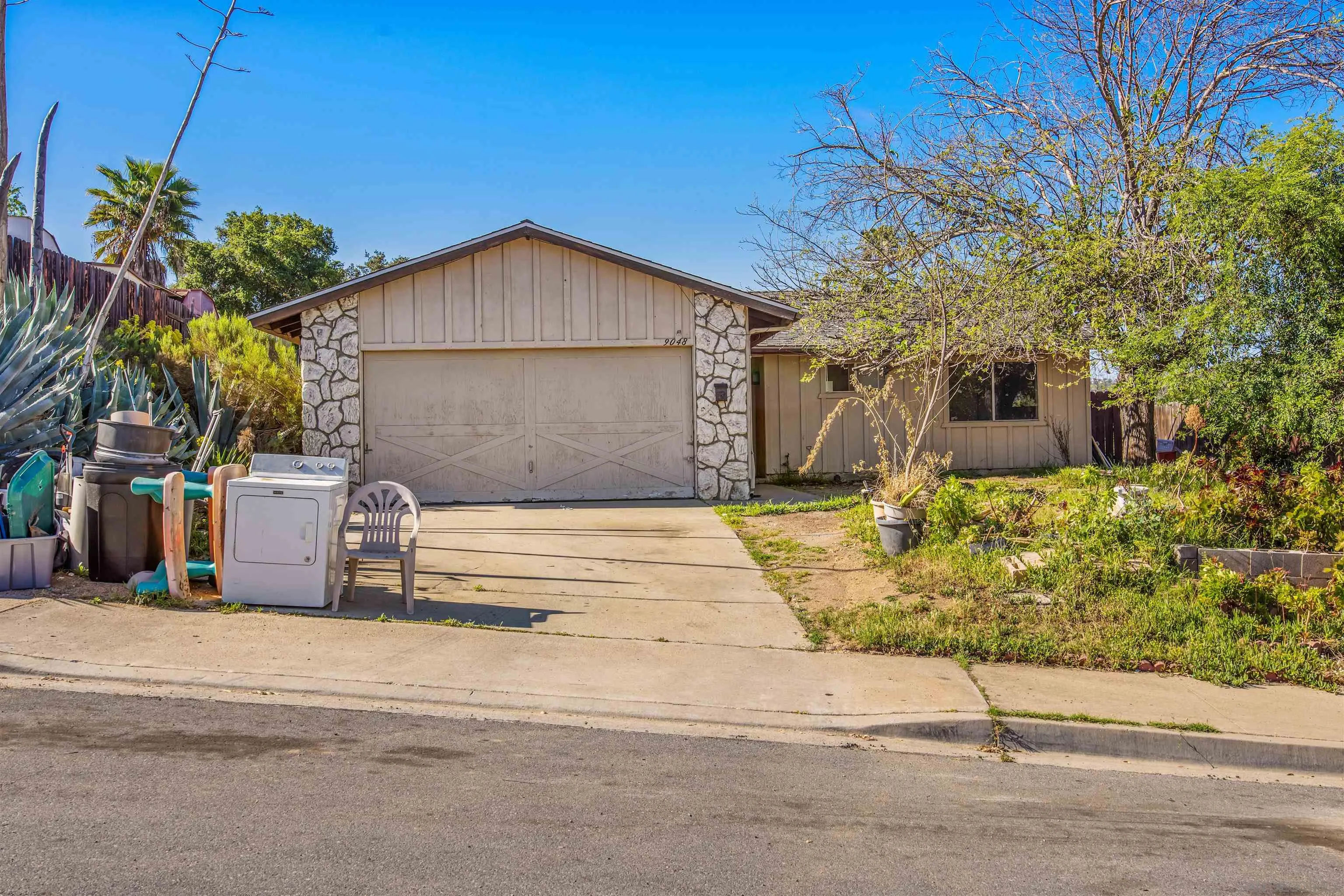 9048 Gideon Circle South Lakeside, CA 92040 - Photo 1 of 21 a front view of a house with a garden