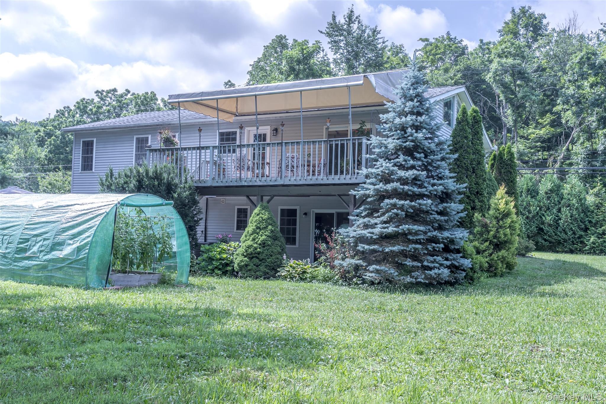 300 Mountain Lodge Road Monroe, NY 10950 - Photo 40 of 41 Rear view of house featuring a yard, a deck, and a greenhouse