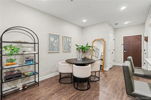 a dining room with furniture and wooden floor