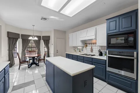 a kitchen with a stove a sink and a refrigerator