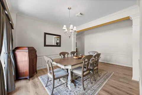 a dining room with furniture and chandelier