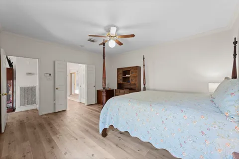 a bedroom with a bed and a chandelier
