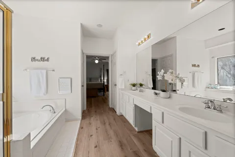 a bathroom with a sink a mirror and a bathtub