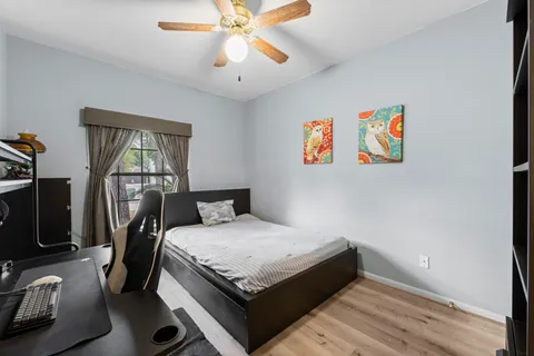 a bedroom with a bed and a chandelier