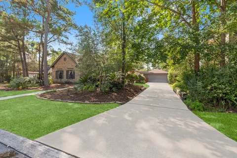 a front view of a house with a yard and trees