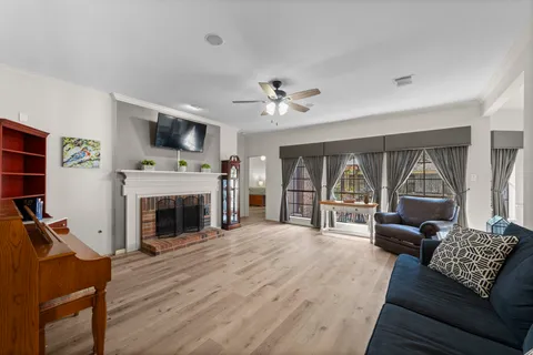 a living room with furniture a fireplace and a flat screen tv